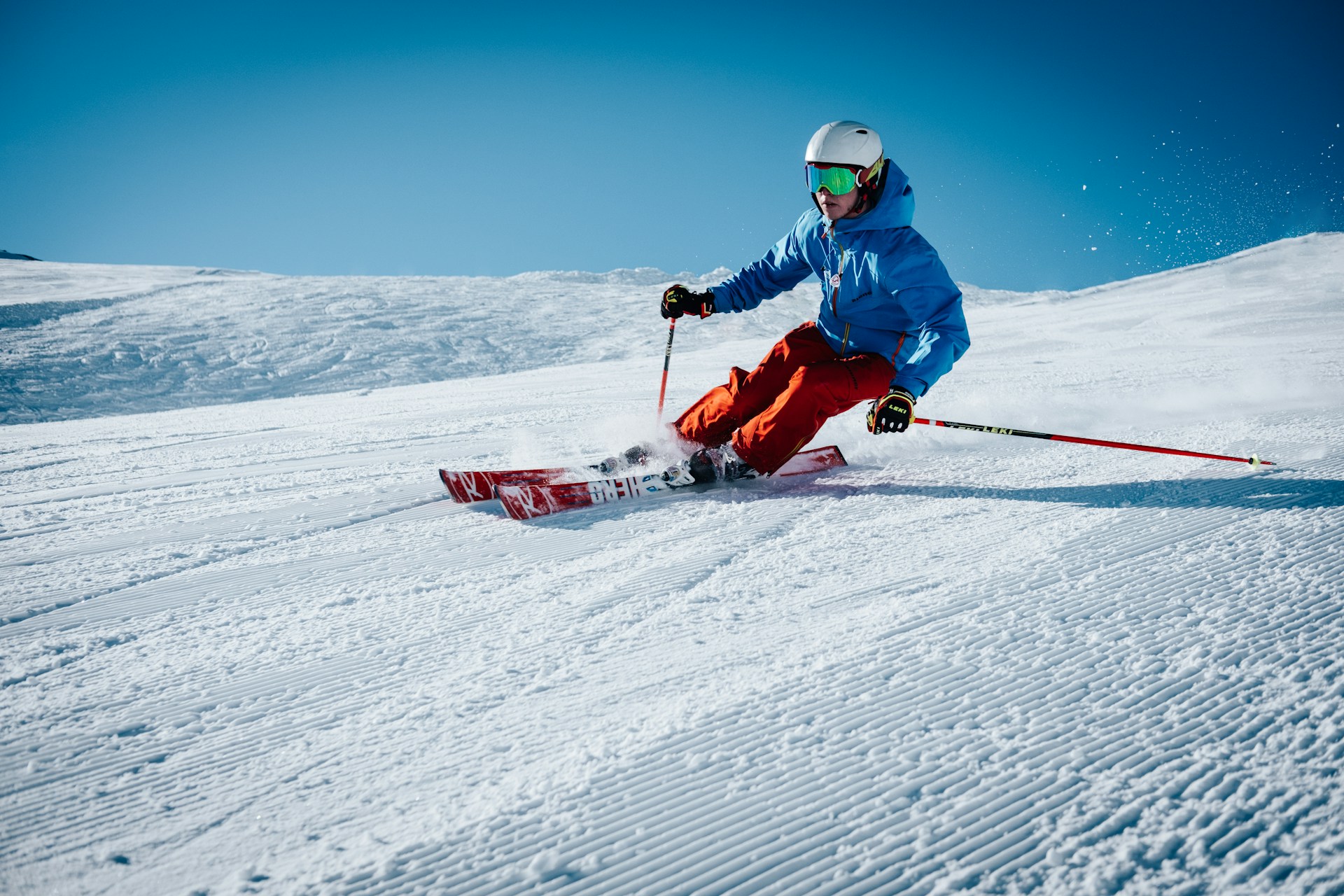 A man skiing down a slope wearing protective gear