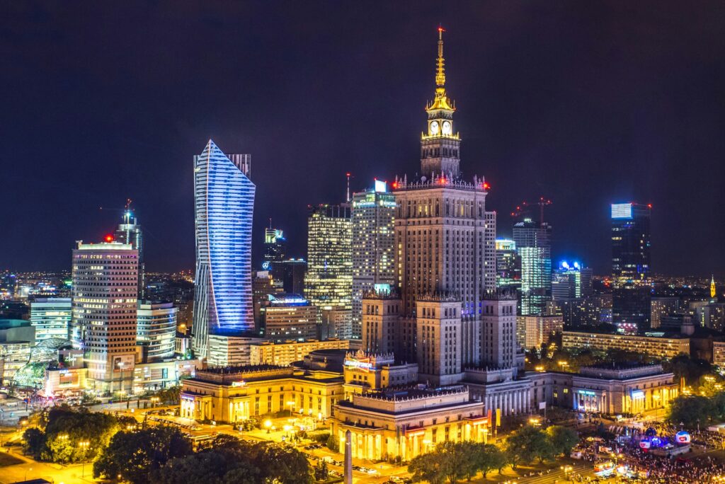 Brightly lit streets and buildings in Warsaw at night