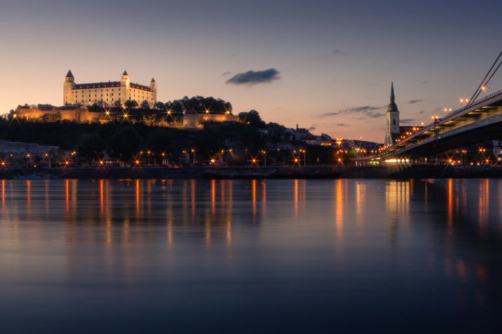 Bratislava's castles and churches behind a view of the Danube river