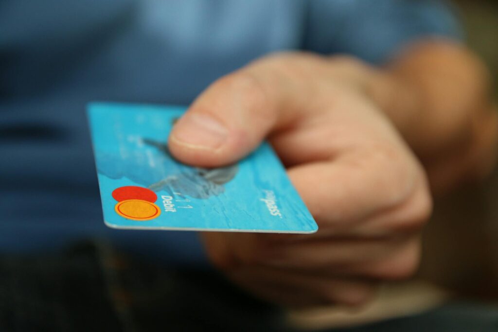 A person handing over a debit card