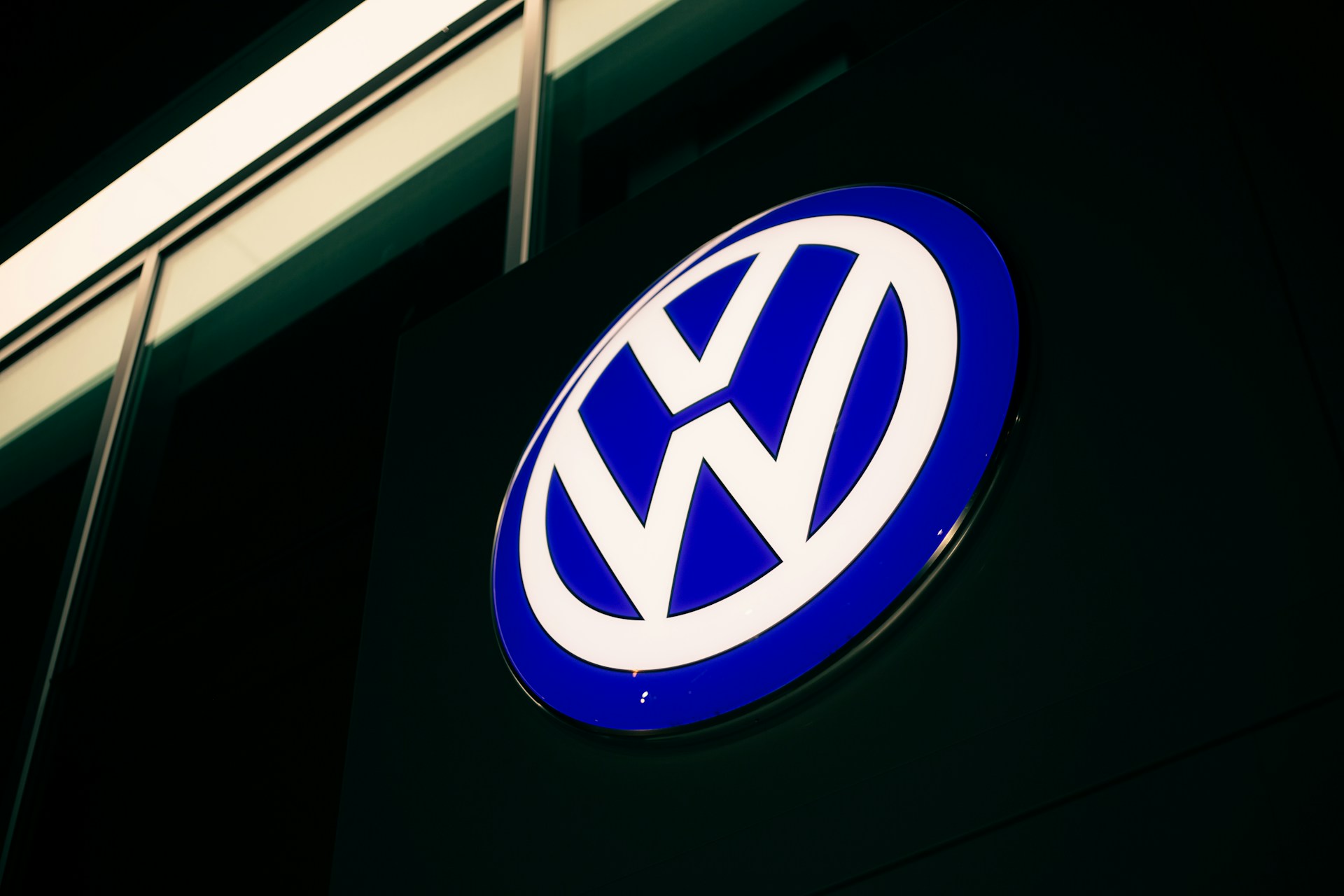 A bright sign of the Volkswagen logo at a showroom
