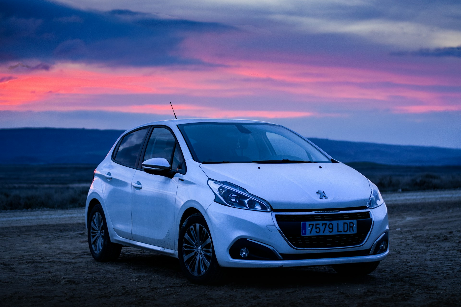 White Peugeot and a pink sunset