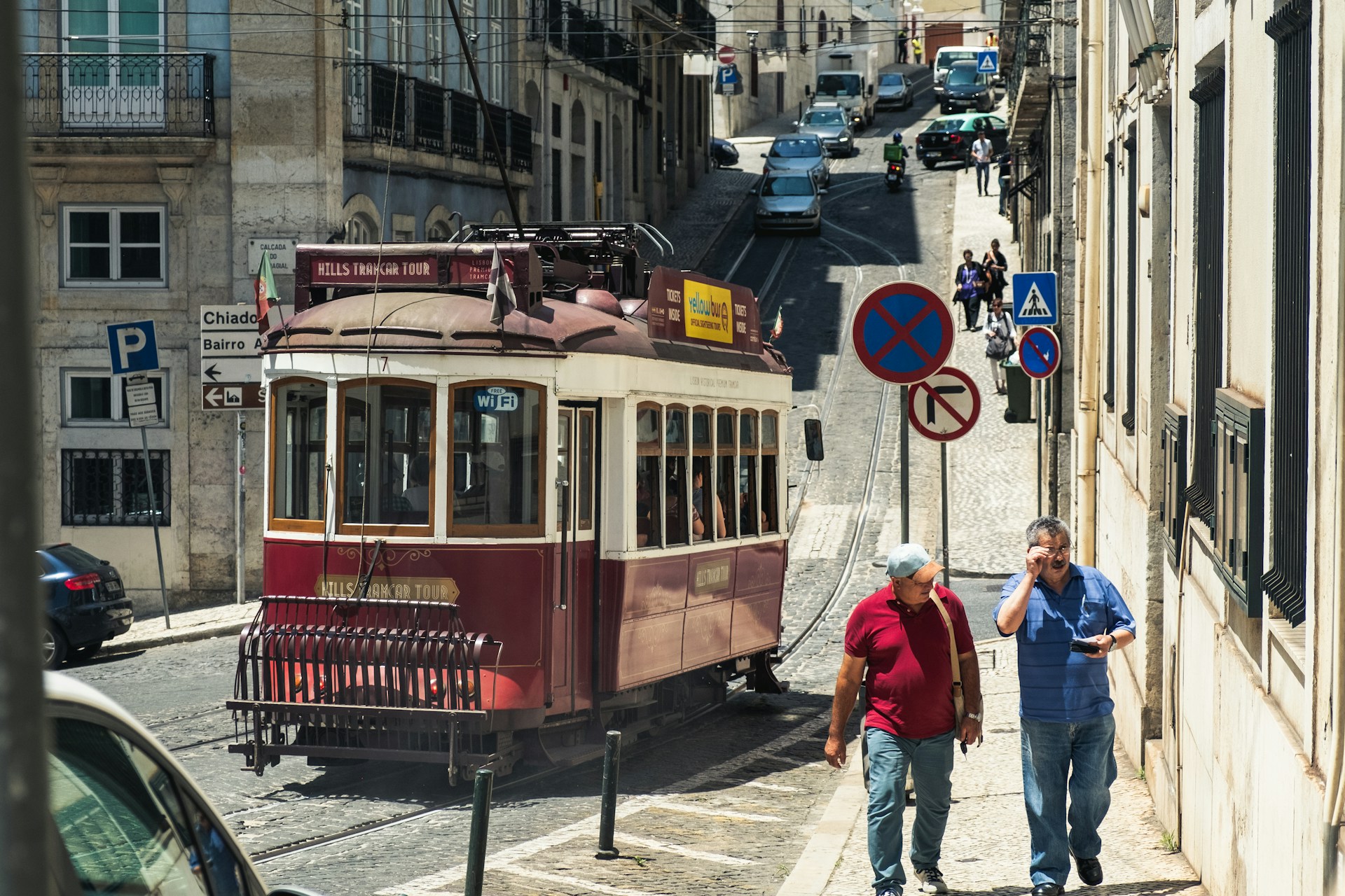 Two local people walking up a street