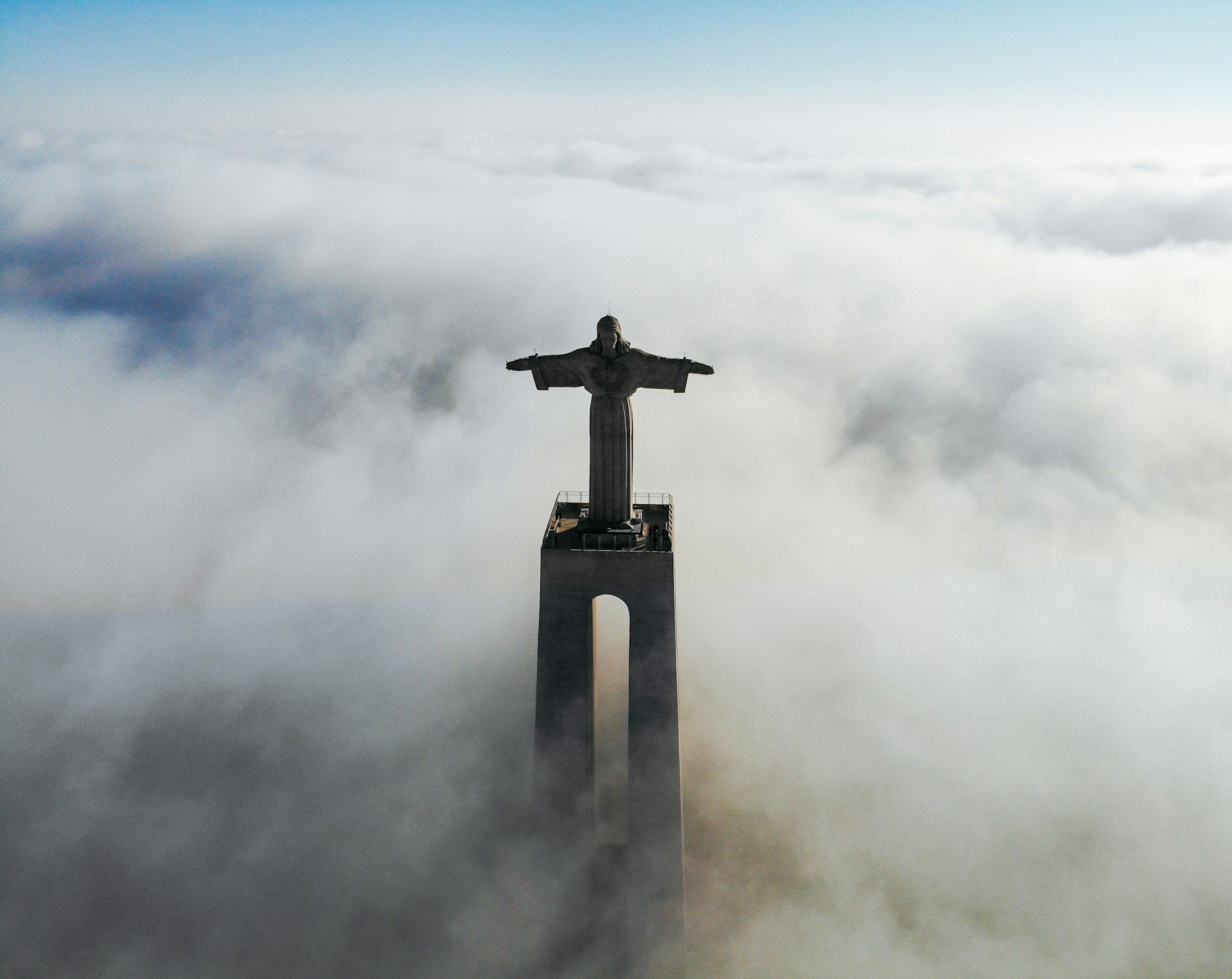 christ redeemer statue covered with clouds at daytime