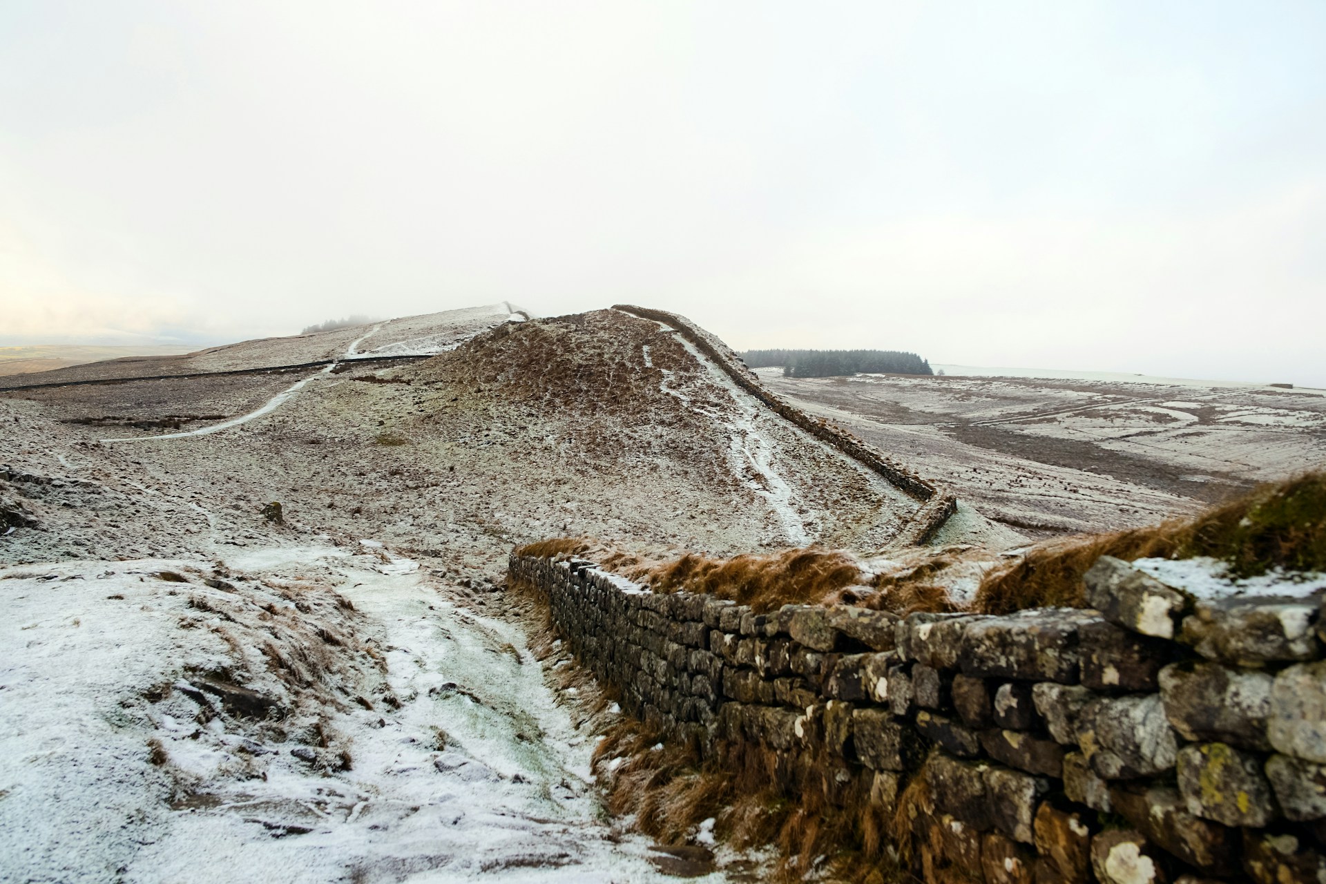 grey bricked wall near mountain