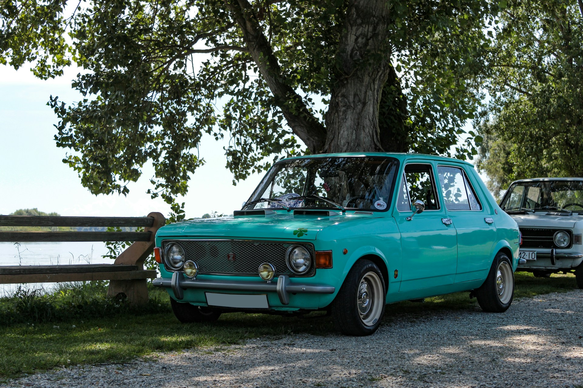 A classic car parked in the shade