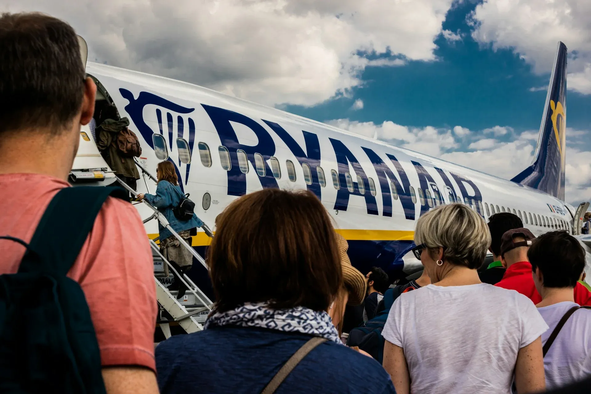 people standing outside an aeroplane