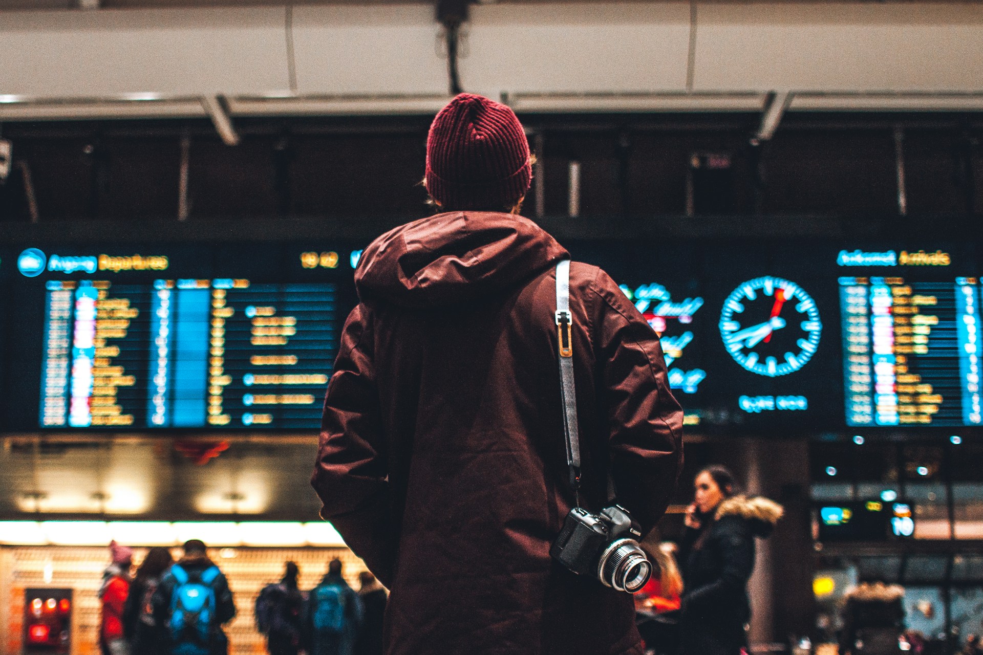 A person looking at an airport departure board